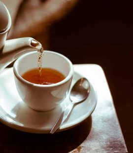Tea Pot Pouring Green Tea With Caffeine Into Tea Cup