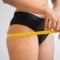 Women measuring her waist to show weight loss